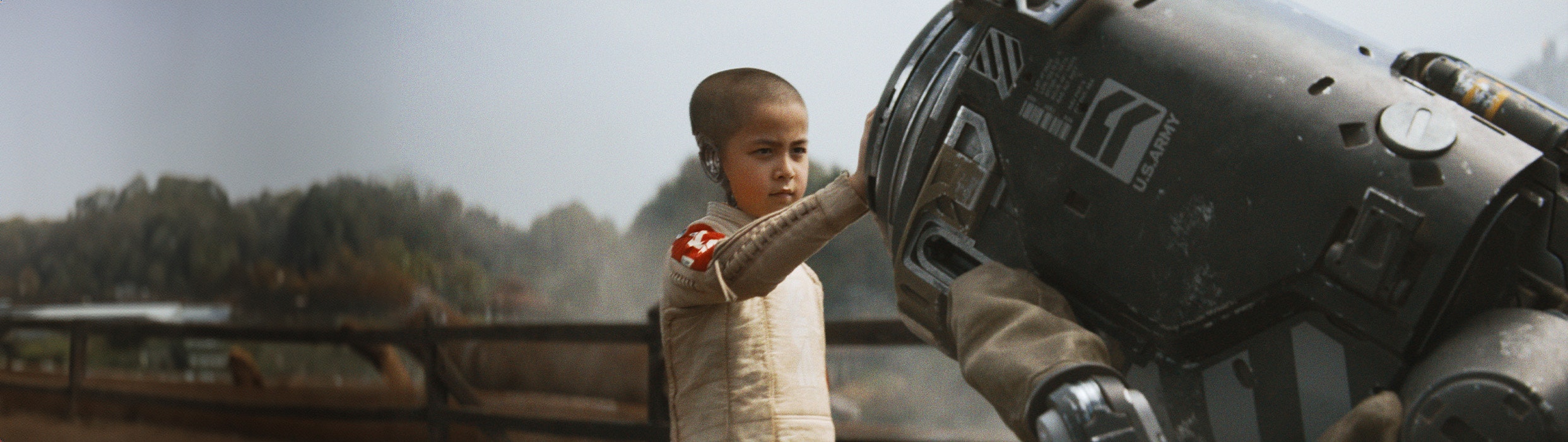 Half human half boy child touches robot with hand in The Creator now showing at Harkins! Get your tickets today!